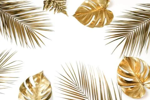 Gold leaves pattern frame on a white background  top view. Gold palm,  monste Stock Photos