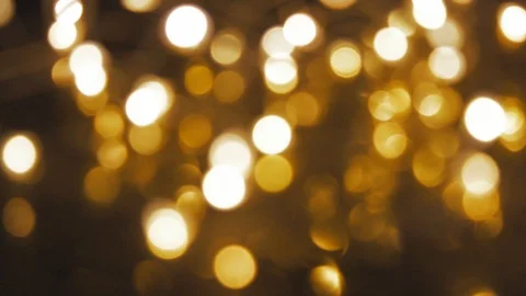 Gold lights drop into a black background Video stock 92814843