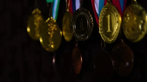 Gold medals on a dark wall Stock Footage 141869325