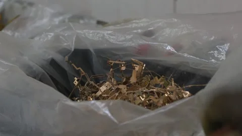 Gold Metal Electronic Connector Scrap in Plastic Bag at Recycling Facility Stock Footage 336424097