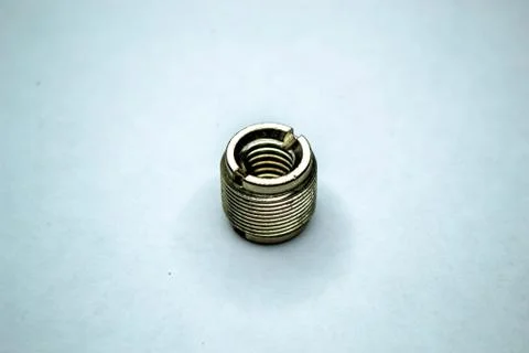 Gold metal nut with thread isolated on white background. Shot of a metal smal 写真素材