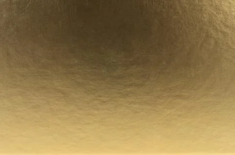 Gold metallic background with subtle texture reflecting light and warmth Foto stock