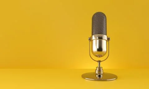 Gold microphone on yellow background. Stock Photos