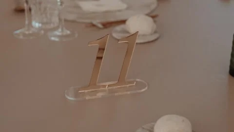 Gold Mirror Table Number Eleven on Acrylic Base at a Set Banquet Table Stock Footage 343697782