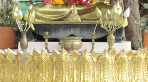 Gold Monk Statue with Flowers Stock Footage 8973752