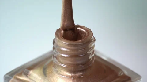 Gold nail polish close up, nail polish brush on edge of bottle. Stock Footage 166364900