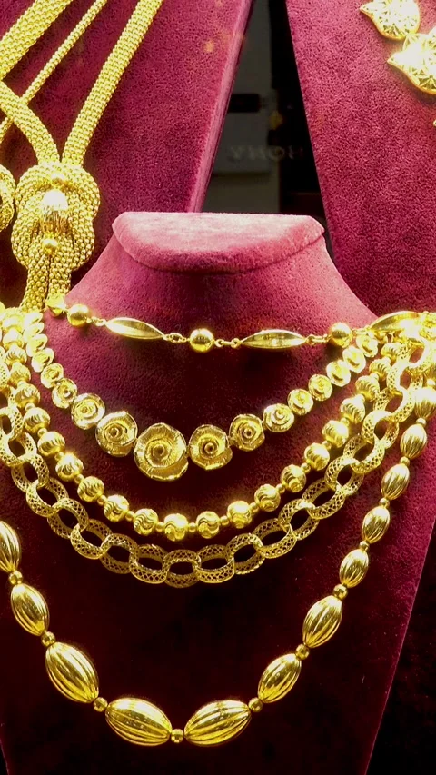 Gold necklaces and chains on red velvet busts Stock Footage 338227057