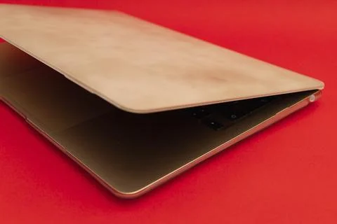 A gold notebook lies on a red background Stock Photos