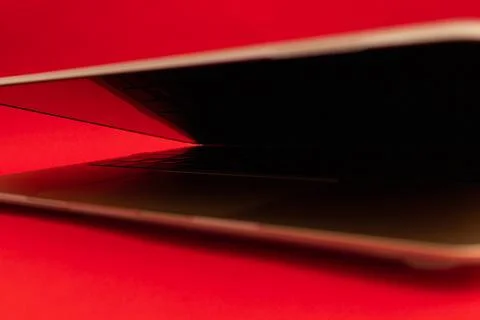 A gold notebook lies on a red background Stock Photos