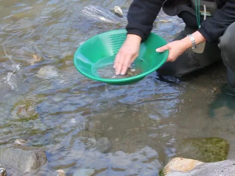 Gold Nugget mining from the River Stockbeeldmateriaal 46317645