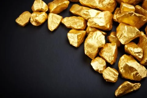 Gold nuggets on a black background. closeup. Stock Photos
