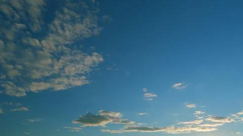 Gold orange sunset sky cloudscape. Dramatic sunset. Summer sky. Timelapse. Stock Photos