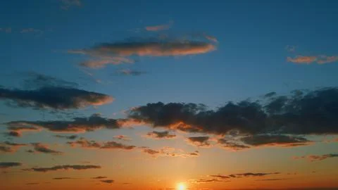Gold orange sunset sky cloudscape. Dramatic sunset. Summer sky. Timelapse. 写真素材
