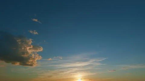 Gold orange sunset sky cloudscape. Dramatic sunset. Summer sky. Timelapse. 스톡 사진