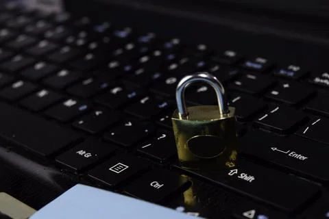 Gold padlock. digital data protection isolated on laptop keyboard backgroun.. Stock Photos