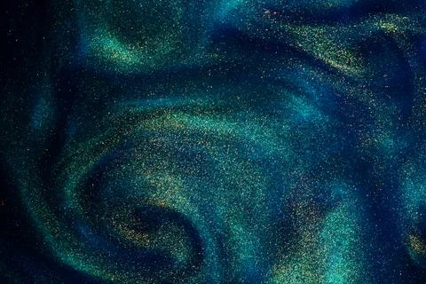 Gold Particles In Blue Fluid. Stock Photos