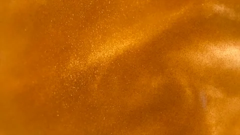 Gold particles floating background, liquid gold, abstract golden backdrop Stockbeeldmateriaal 334376433