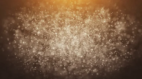 Gold particles floating on an orange background Видео 100139360