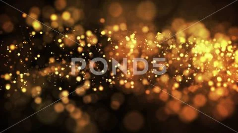 Gold particles glisten in the air, gold sparkles in a viscous fluid have the Stock Photos