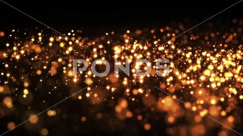Gold particles glisten in the air, gold sparkles in a viscous fluid have the Stock Photos