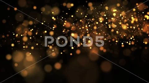 Gold particles glisten in the air, gold sparkles in a viscous fluid have the Stock Photos