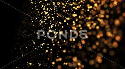 Gold particles glisten in the air, gold sparkles in a viscous fluid have the Stock Photos