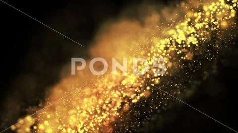 Gold particles glisten in the air, gold sparkles in a viscous fluid have the Stock Photos