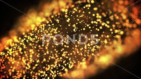Gold particles glisten in the air, gold sparkles in a viscous fluid have the Stock Photos