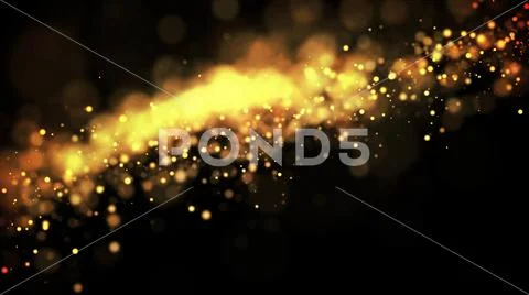 Gold particles glisten in the air, gold sparkles in a viscous fluid have the Stock Photos