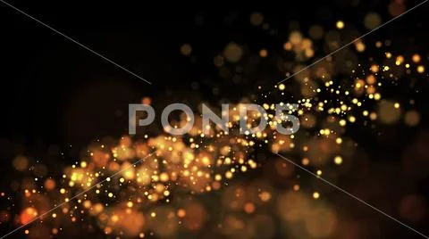 Gold particles glisten in the air, gold sparkles in a viscous fluid have the Stock Photos