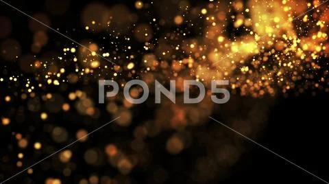 Gold particles glisten in the air, gold sparkles in a viscous fluid have the Stock Photos