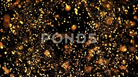 Gold particles glisten in the air, gold sparkles in a viscous fluid have the Stock Photos