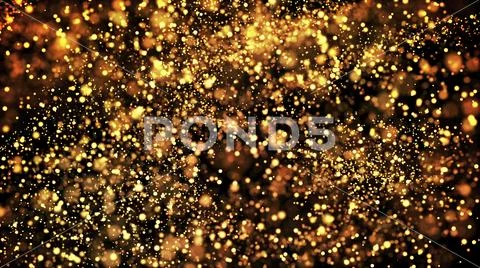 Gold particles glisten in the air, gold sparkles in a viscous fluid have the Stock Photos