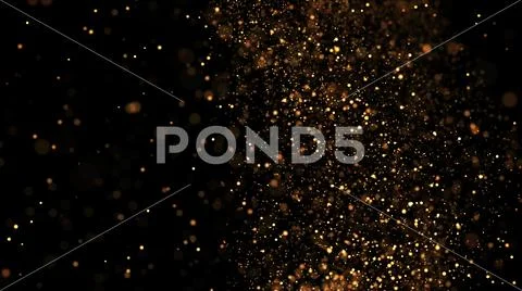 Gold particles glisten in the air, gold sparkles in a viscous fluid have the Stock Photos