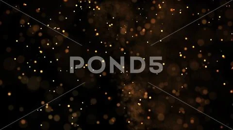Gold particles glisten in the air, gold sparkles in a viscous fluid have the Stock Photos