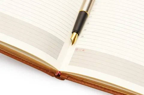 Gold pen on diary Stock Photos