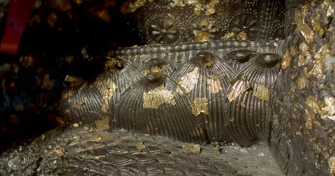 The gold plate attached to the base of the Buddha image flutters in the wind. Stock Footage 310630911