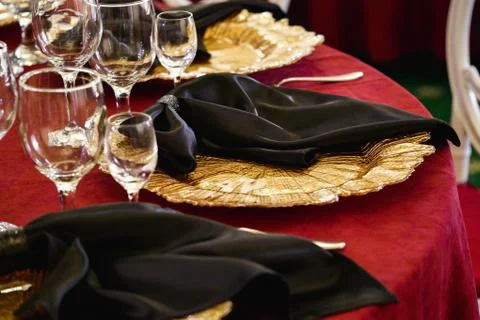 Gold plate, decorations, table setting, red tablecloths Stock Photos