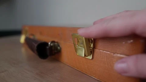 The gold-plated latch on the suitcase opens Stock Footage 169835270