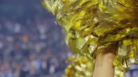 Gold Pom Poms shaken at an NFL football game Stock Footage