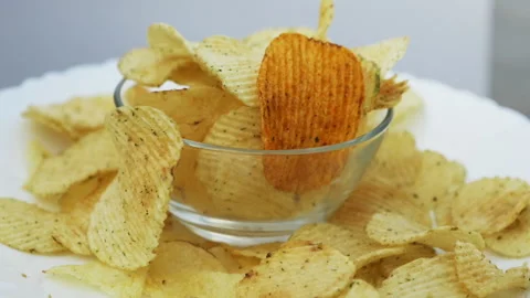 Gold potato chips rotating close up Video stock 139812777