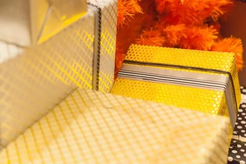 Gold present boxes package with silver ribbons as holiday gift boxes for fest Stock Photos