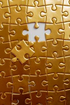 Gold puzzles with one piece missing, flat lay. Nobody Stock Photos