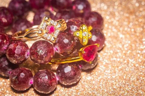 Gold ring and ruby beaded bracelet Stock Photos