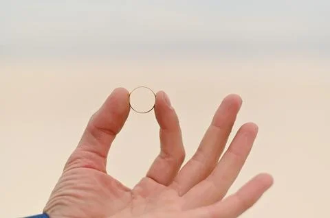 A gold ring close-up. an engagement ring for the bride in the groom's hand Stock Photos