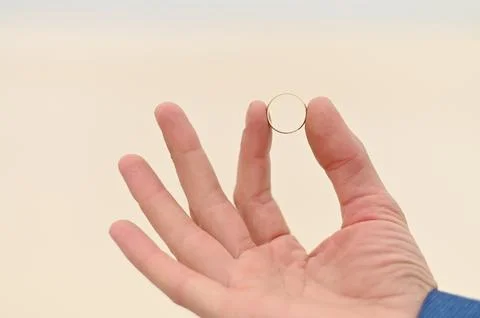 A gold ring close-up. wedding ring for the bride in the man's hand Stock Photos