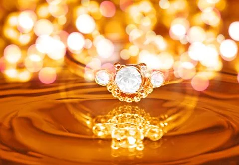 Gold ring featuring three clear faceted stones Stock Photos