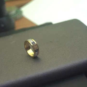 A gold ring on a gray book  Stock Photos