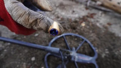 Gold ring with a large blue stone, painted on the riverbank Stock Photos