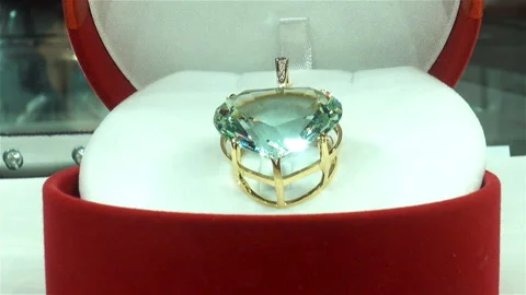 A gold ring with a large gem in a case. Stock Footage 122494549